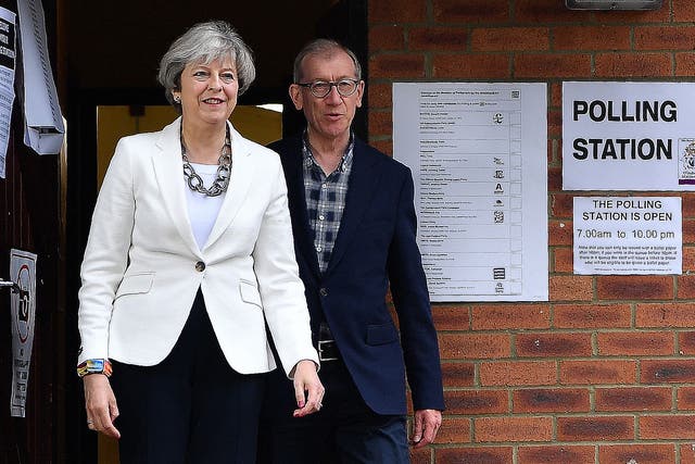 Theresa May and her husband Philip, leave a polling station after voting in the 2017 elections