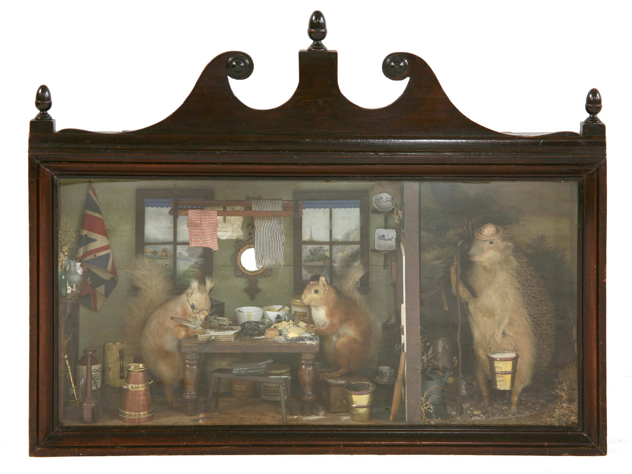 Diorama of two squirrels preparing food at the kitchen table and a hedgehog knocking at the front door, sold for £2000 at auction