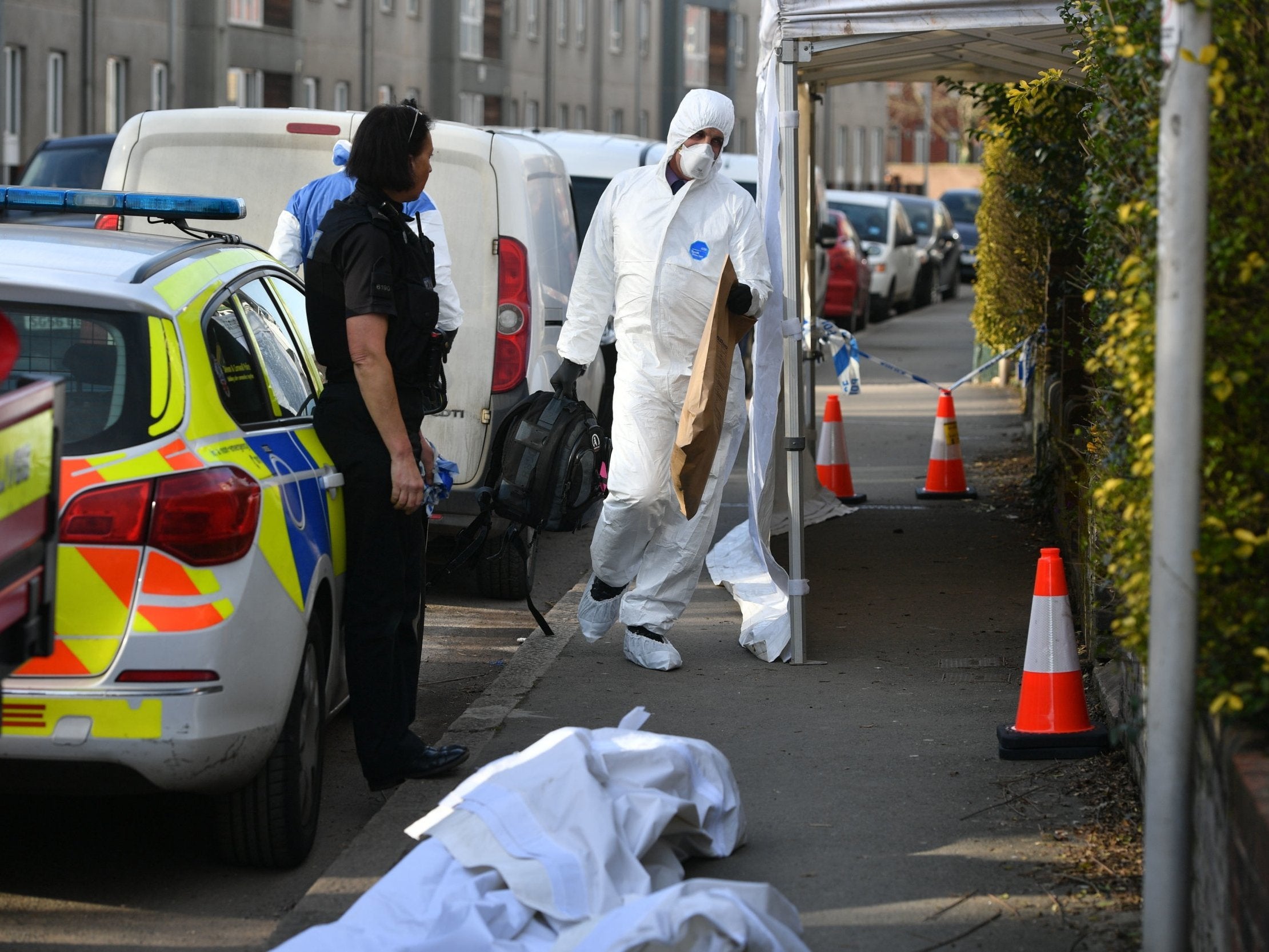 Forensic officers outside house in Bonhay Road, where one body was found