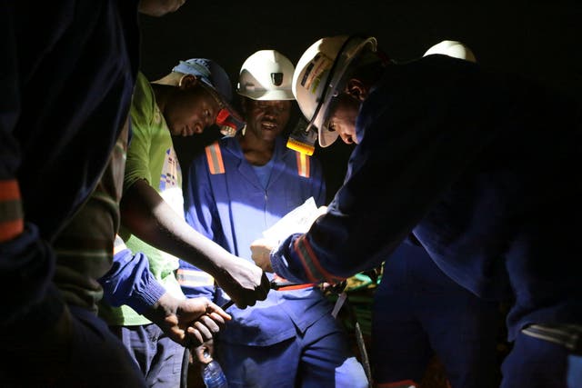 Established miners fix broken equipment used to help rescue dozens of artisanal miners, who are feared dead after rains flooded the mines while they were underground, on the outskirts of Kadoma town about 200 kilometers (124 miles) west of Harare, Zimbabwe, Friday, Feb. 15, 2019.