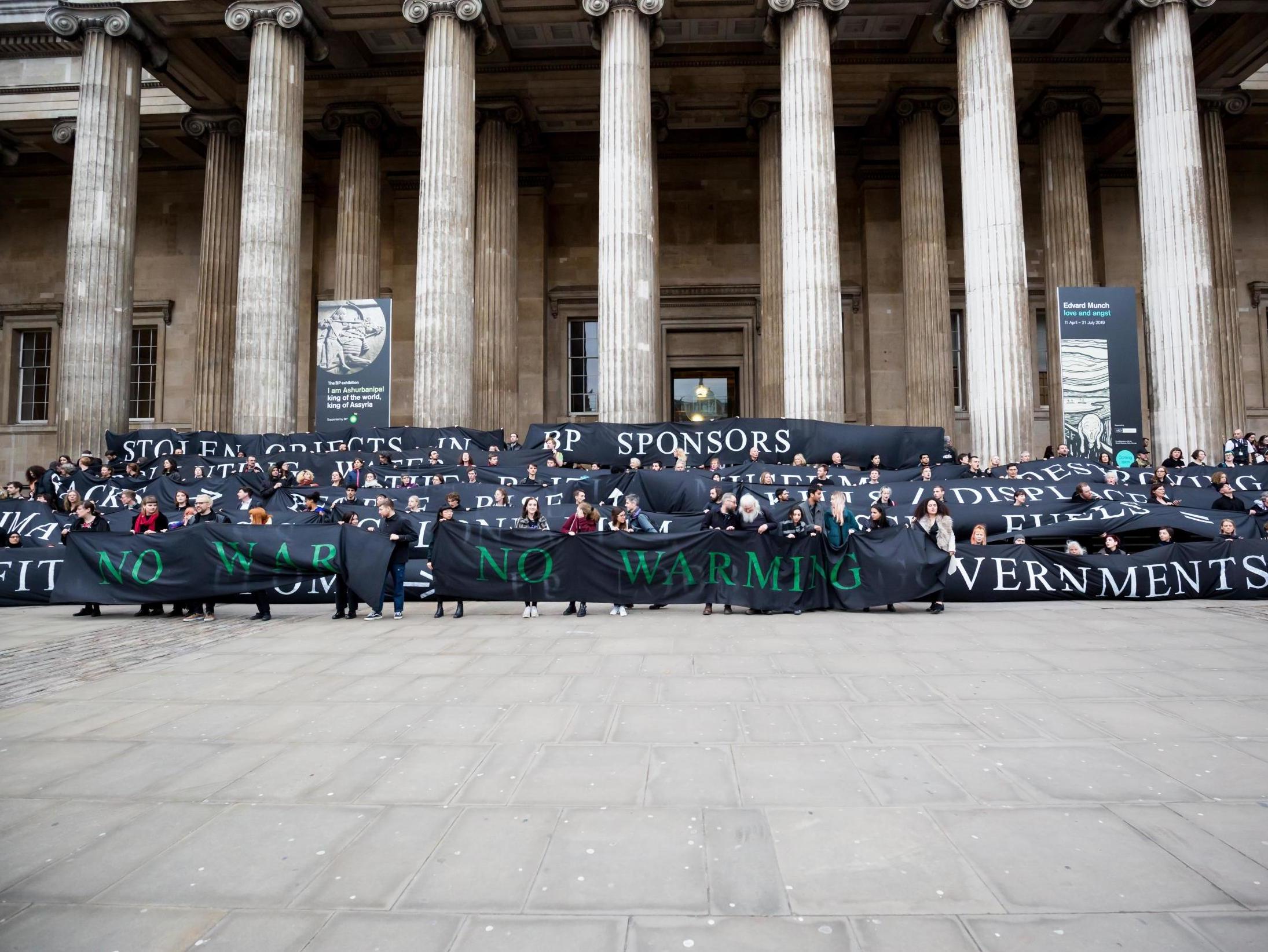 Around 350 protesters wrapped a large cloth banner around the museum's great hall.