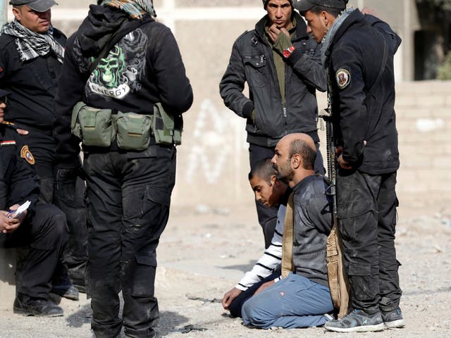 An Iraqi Special forces intelligence team talk to suspected Islamic State fighters in Mosul, Iraq, in 2016