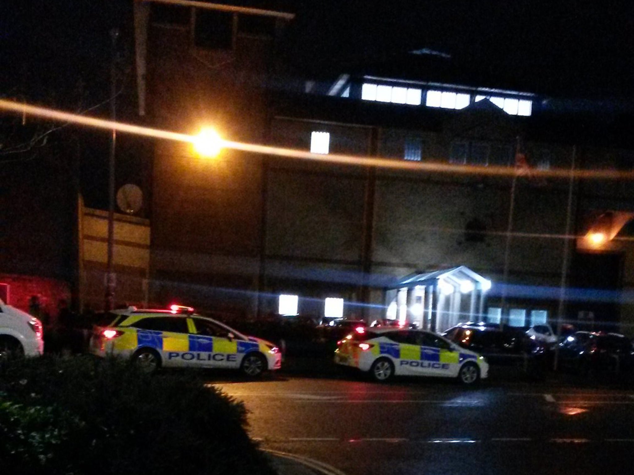Police outside HMP Bedford, where a specialist riot unit quashed six hours of unrest