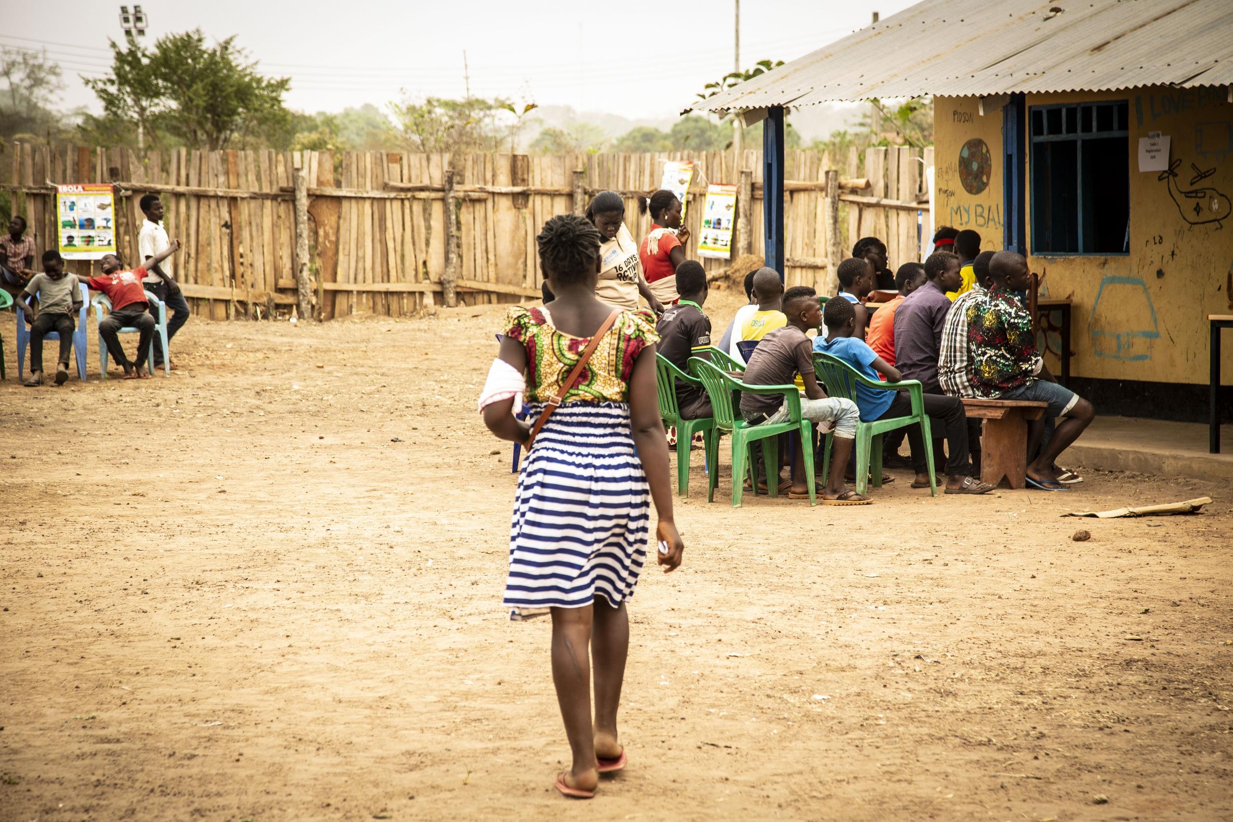 Martha queues up with other children to receive an official document in Yambio saying she has been released from the army