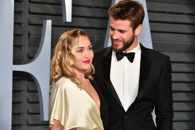 Miley Cyrus (L) and Liam Hemsworth attend the 2018 Vanity Fair Oscar Party