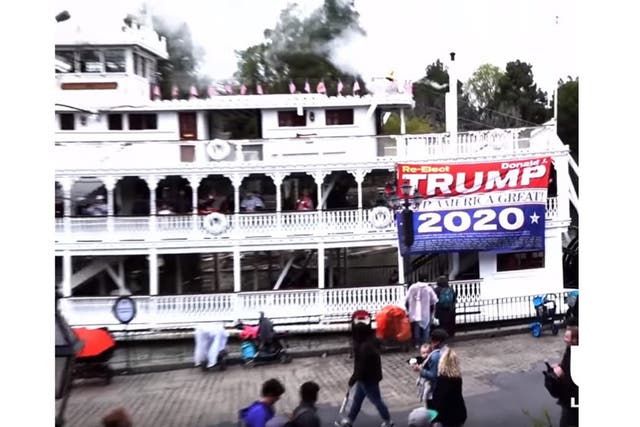 Cini unfurls the Donald Trump 2020 flag onboard the Mark Twain Riverboat ride at Disneyland