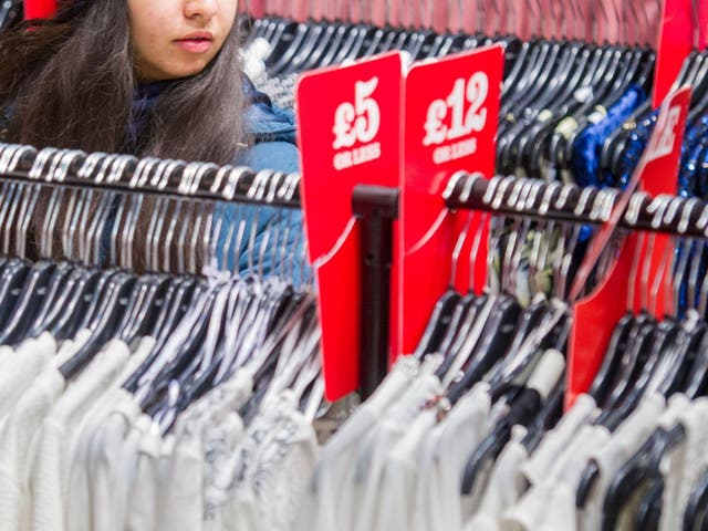 File photo dated 26 December 2014 of a woman looking at clothes in a shop