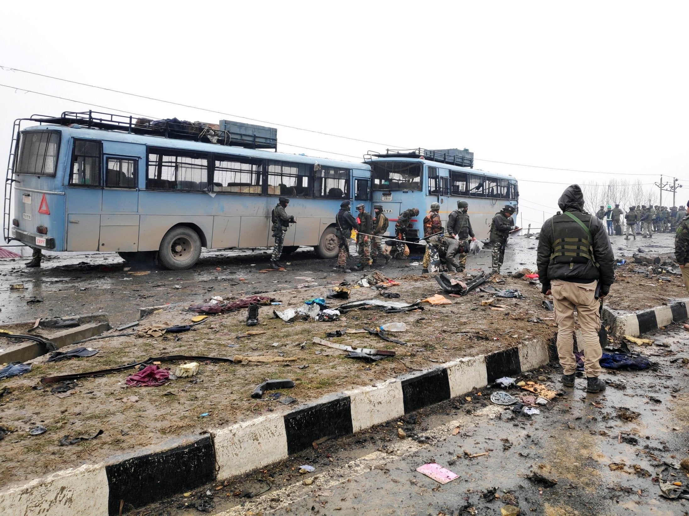 Indian soldiers examine the debris after an explosion in Lethpora in south Kashmir’s Pulwama district 14 February 2019.