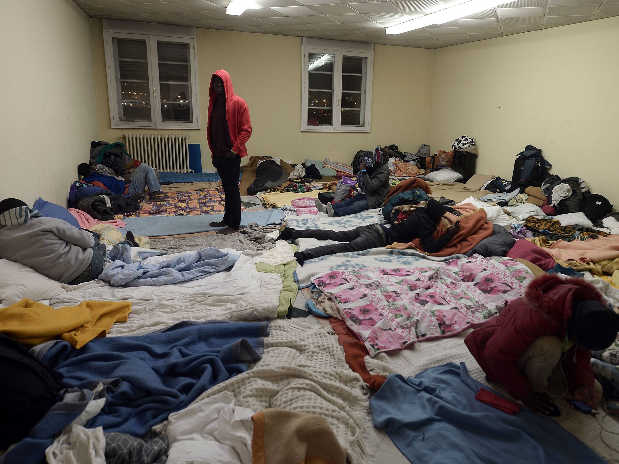 Migrants wait to spend a night at the offices of association Diakite in Bayonne, southwest France in November