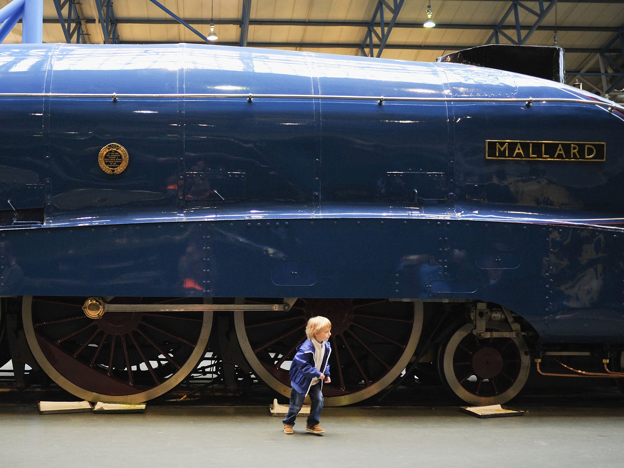 A child plays next to the Mallard at the National Railway Museum. The train was the fastest steam locomotive that was built on 3 March 1938