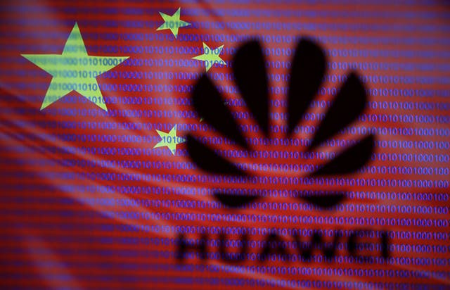 Huawei logo is seen in front of displayed flag of China and cyber code