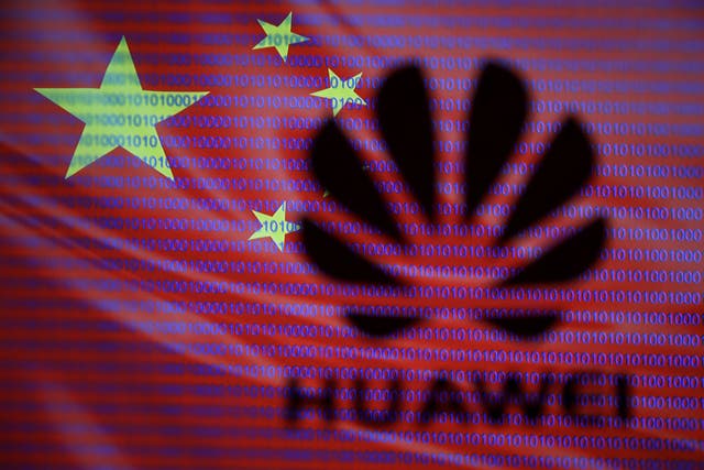 Huawei logo is seen in front of displayed flag of China and cyber code