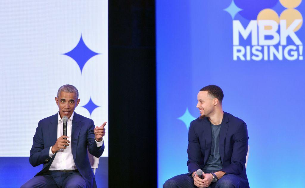 Former President Barack Obama speaks alongside Golden State Warriors basketball player Stephen Curry during the MBK Rising! My Brother's Keeper Alliance Summit in Oakland