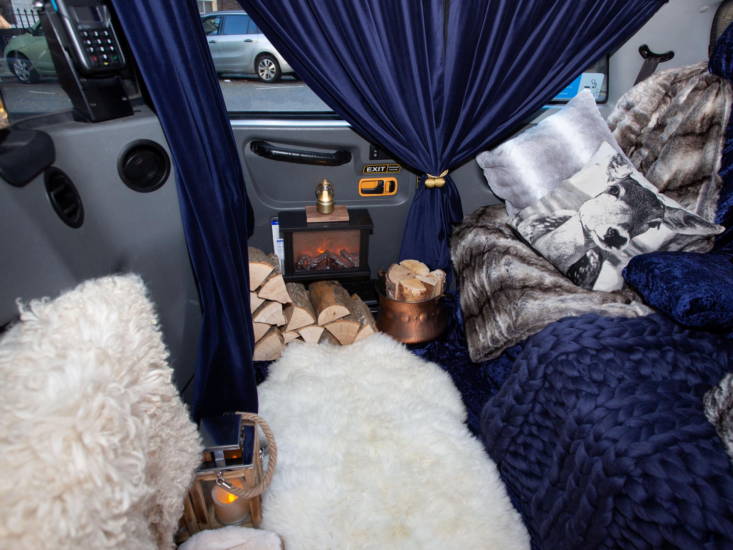 The wood-cabin inspired Baxi Taxi is decked out with curtains and faux fur rugs