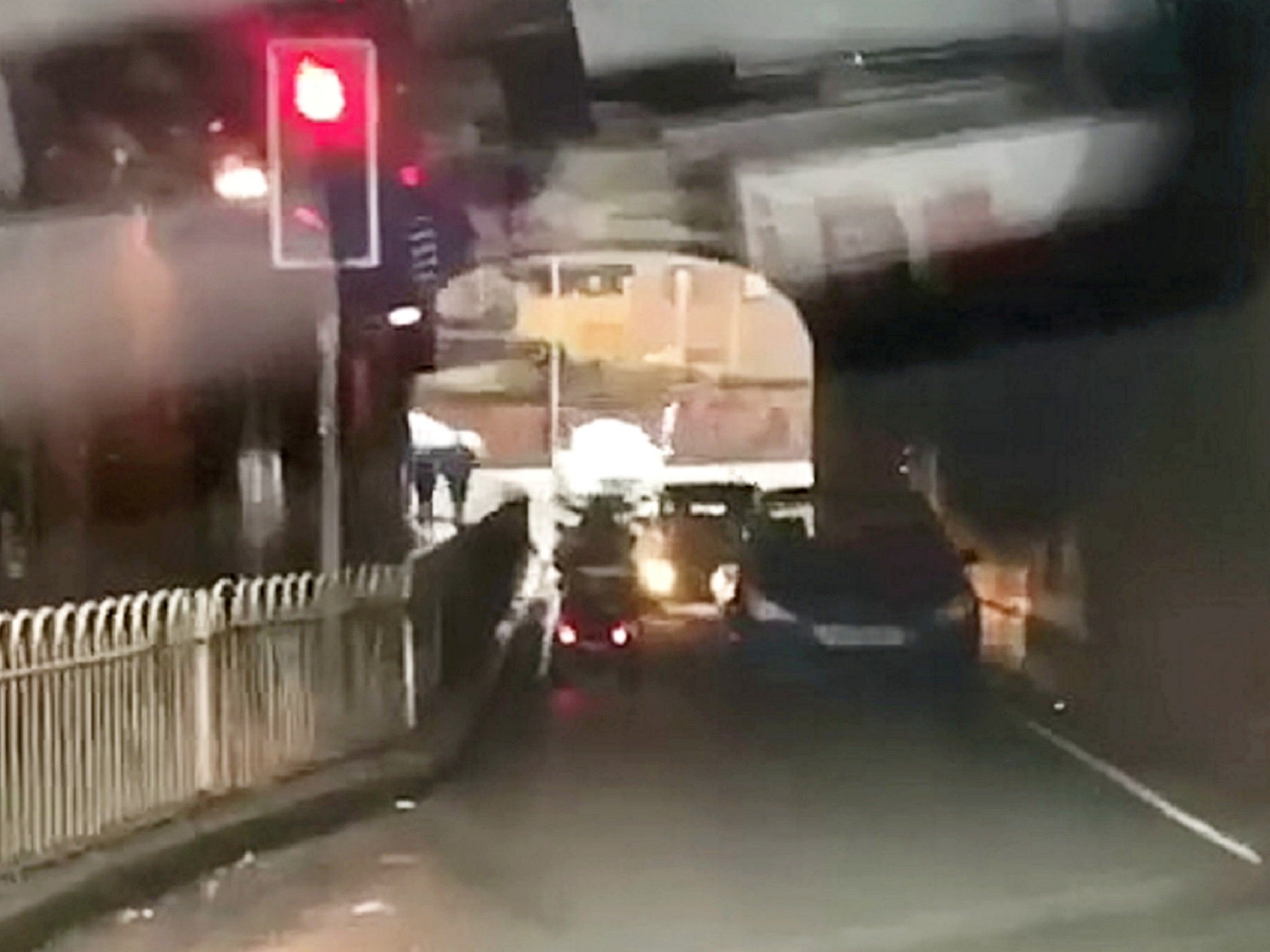 Elderly man filmed driving mobility scooter through red light then into oncoming traffic under bridge in Worcester, West Midlands.