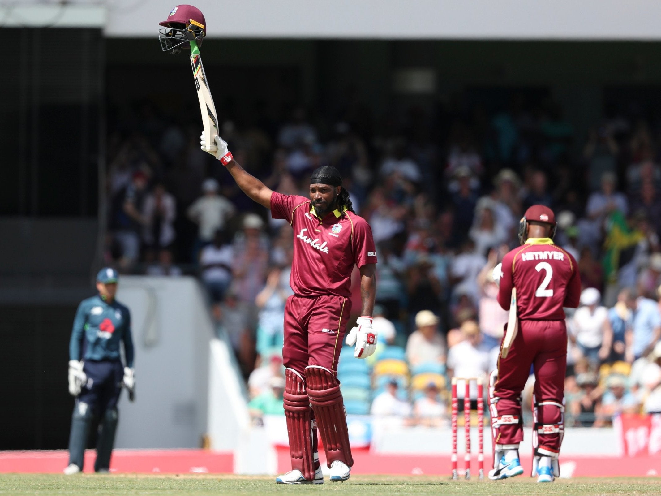 Chris Gayle celebrates scoring his century against England