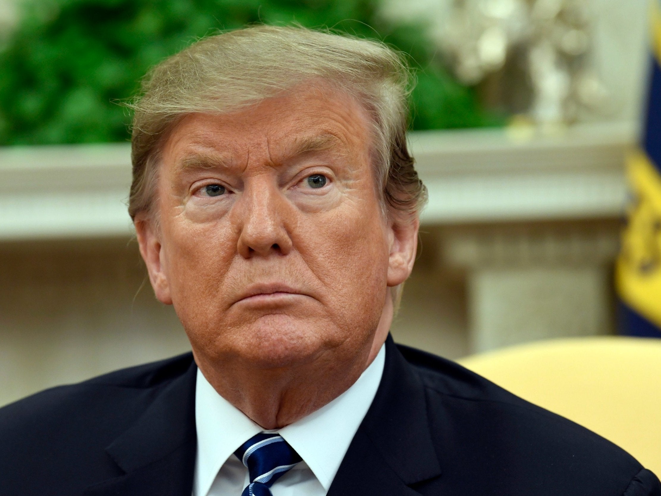 President Donald Trump listens during his meeting with Austrian Chancellor Sebastian Kurz in the Oval Office