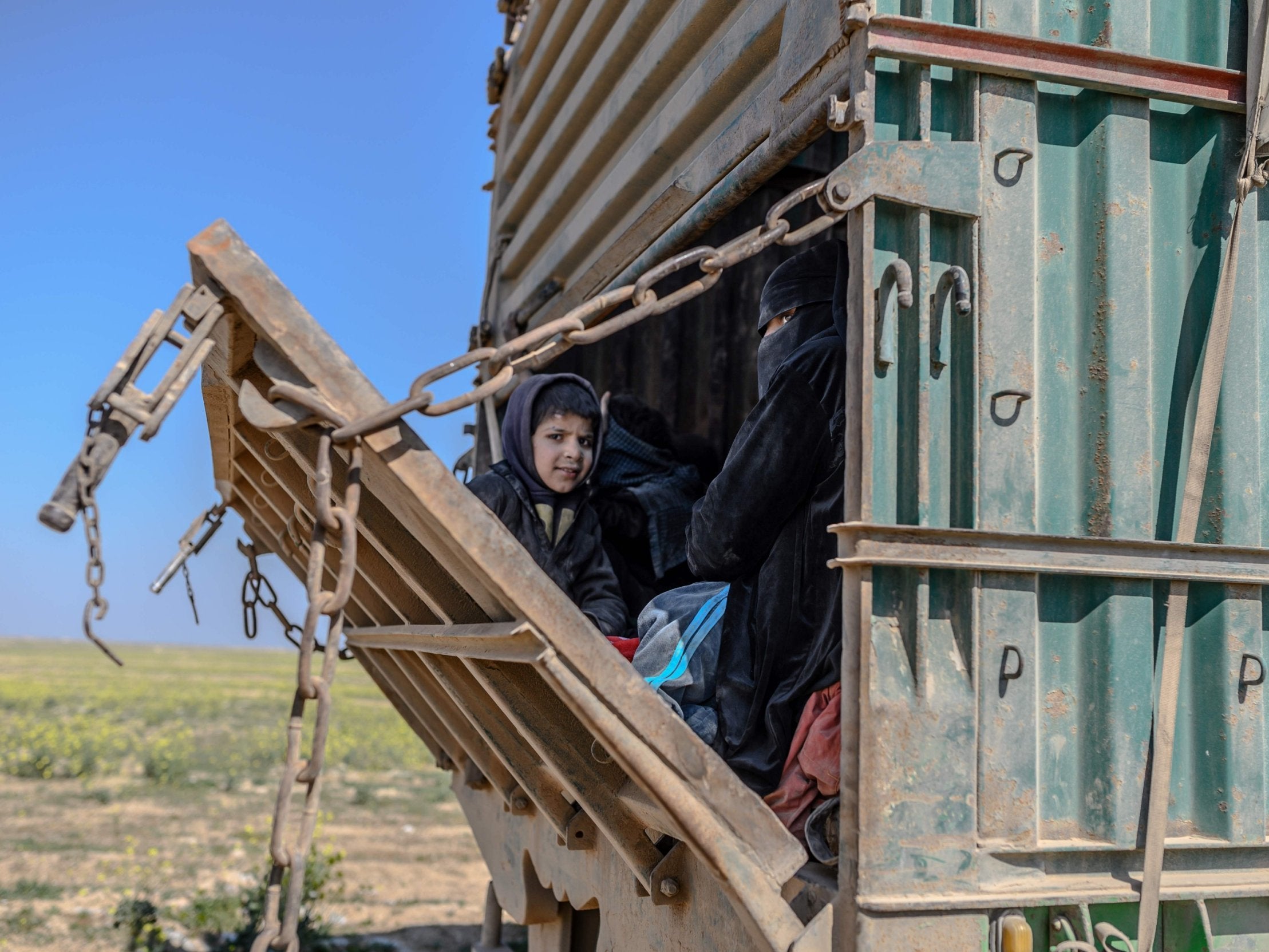 A convoy of vehicles led by the SDF transports fighters believed to be surrendering members of Isis and their families out of Baghouz on Wednesday