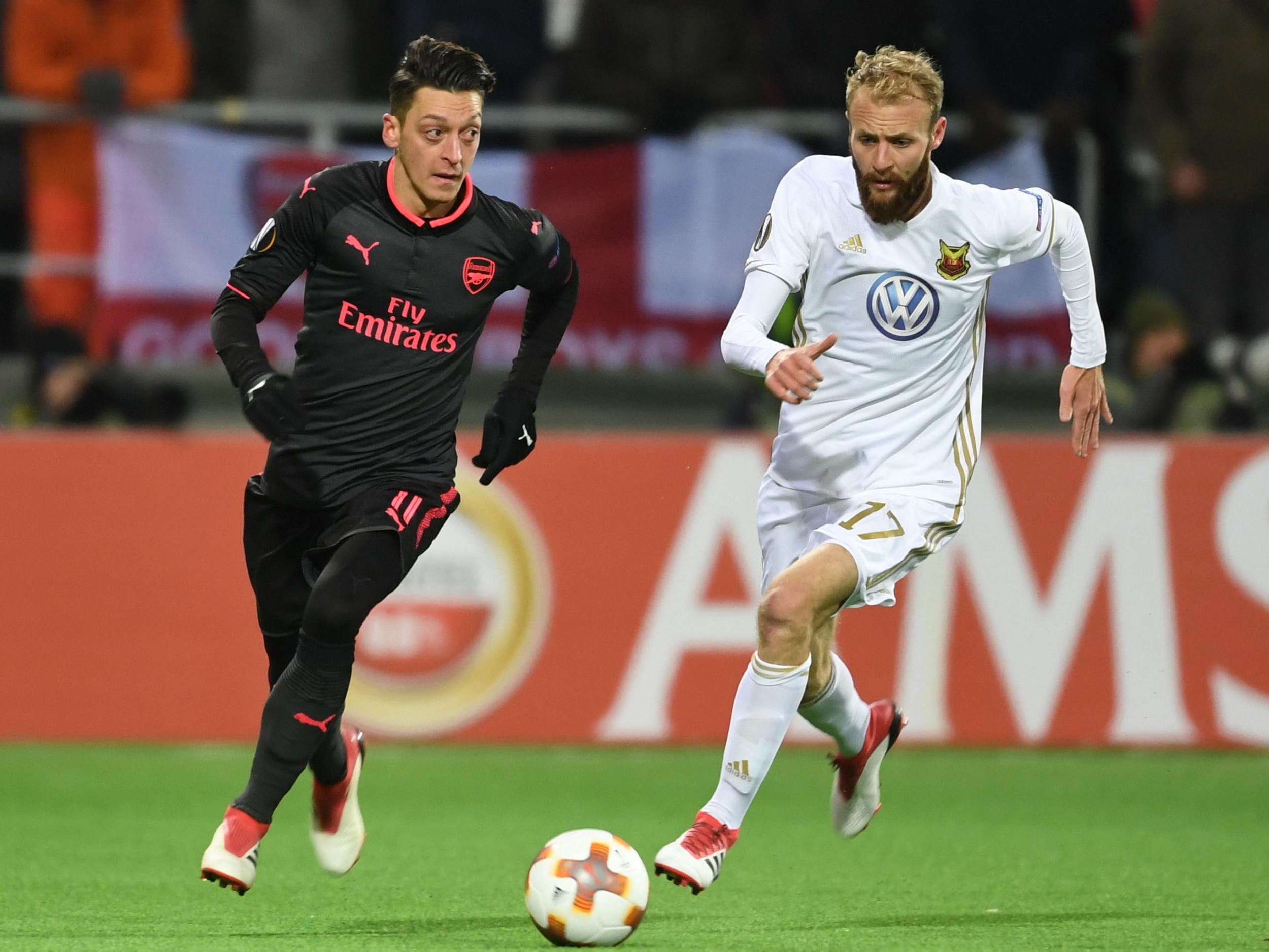 Curtis Edwards chases after Arsenal’s Mesut Ozil