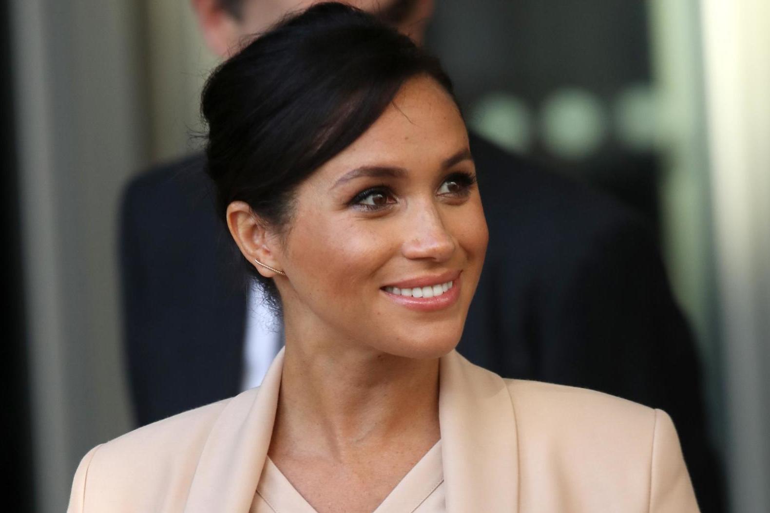 The Duchess of Sussex walks to her car after visiting the National theatre in central London on January 30, 2019