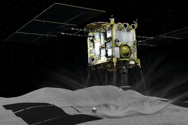 A computer graphic handout image shows Japan Aerospace Exploration Agency's Hayabusa 2 probe touches down on an asteroid, in this image released by Japan Aerospace Exploration Agency