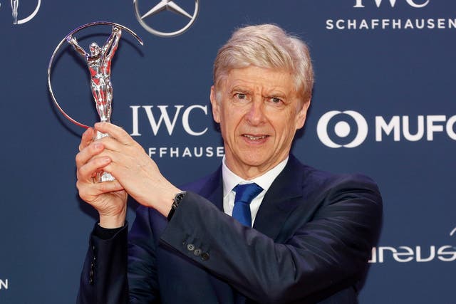 Arsene Wenger poses with his Laureus World Sports Lifetime Achievement Award