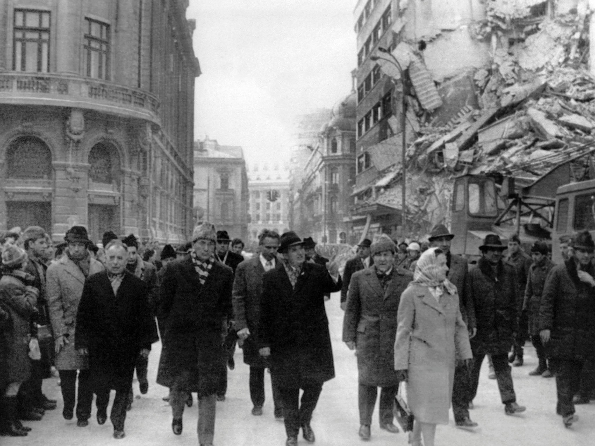 Romanian president Nicolae Ceausescu (centre) observes the damage in Bucharest after the Vrancea earthquake in 1977