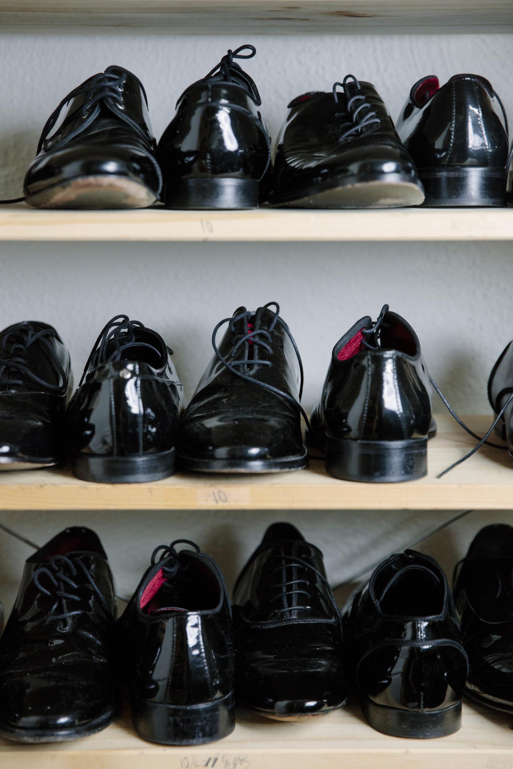 Dozens and dozens of men's shoes line shelves in Ilaria Urbinati's studio.