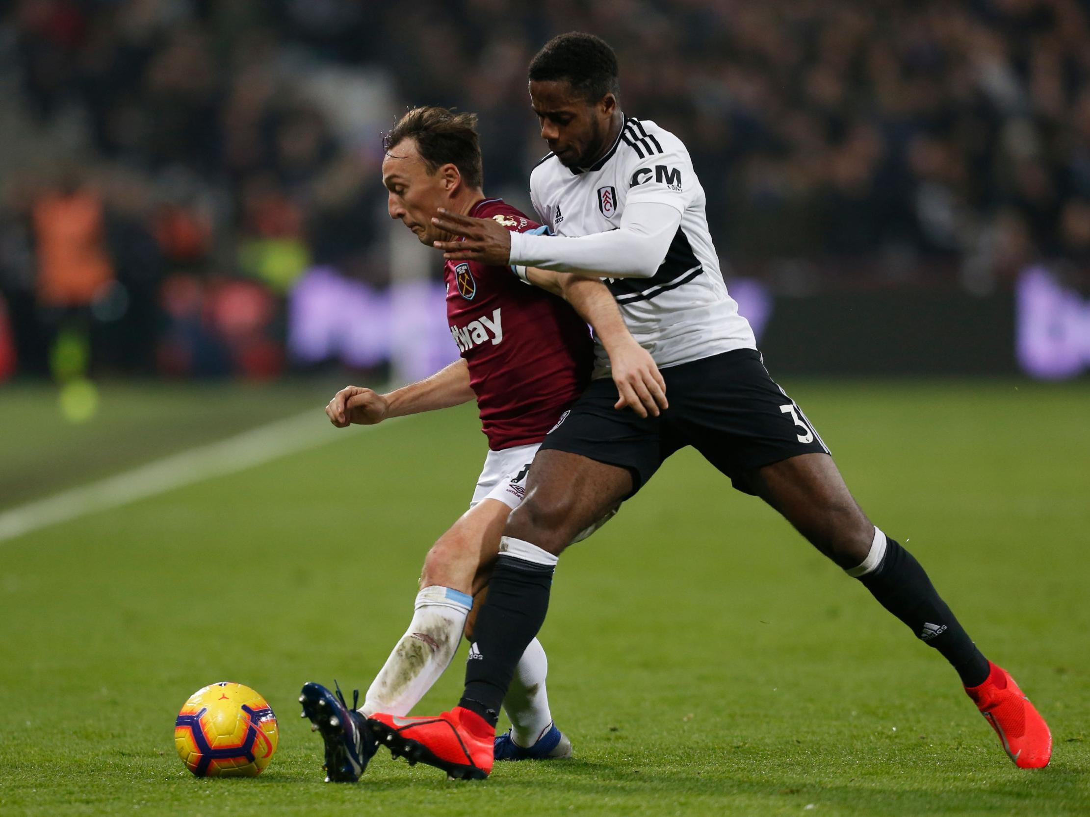 Mark Noble vies for possession with Ryan Sessegnon