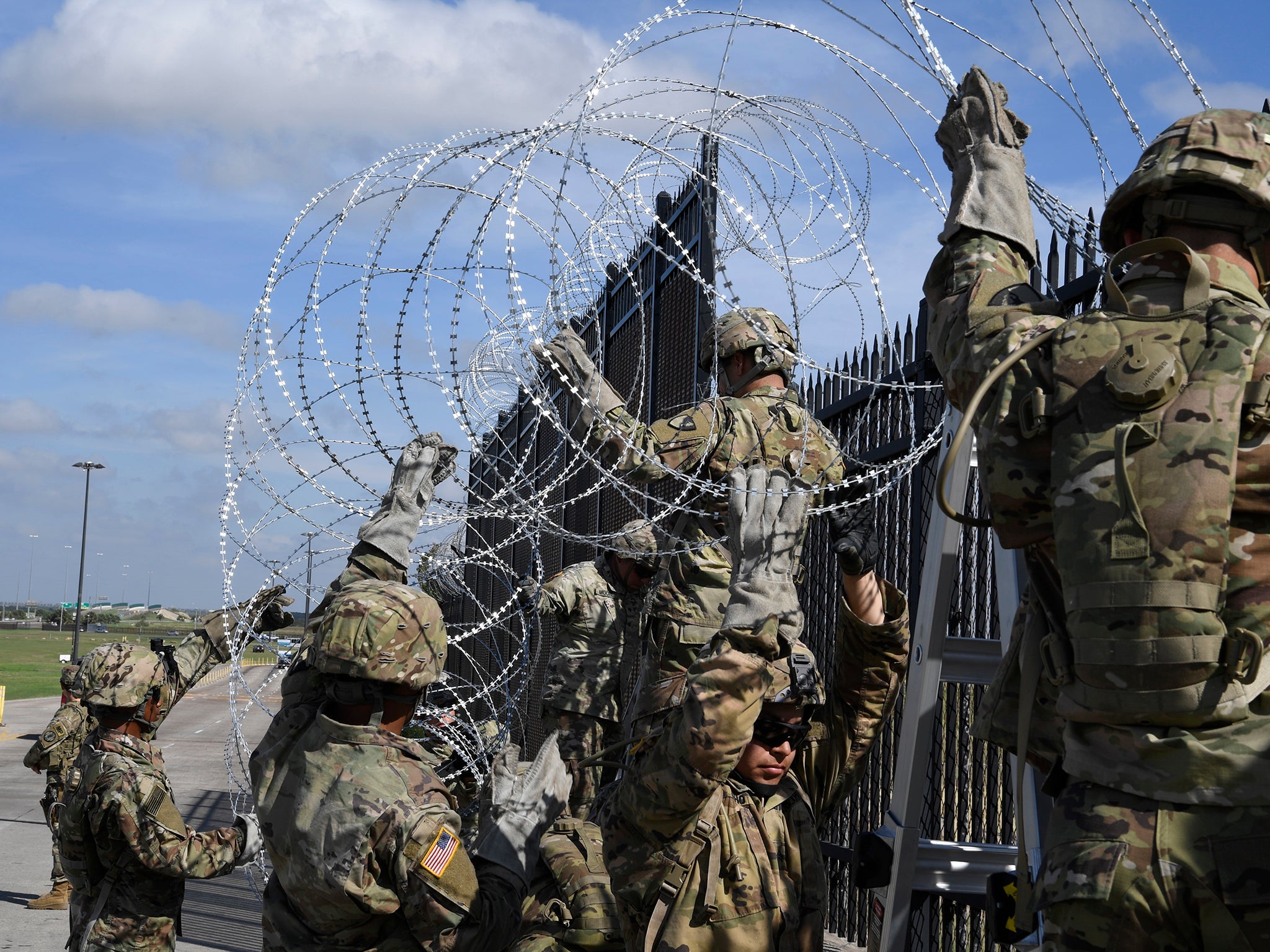 Troops currently stationed at the US-Mexico border have been ordered to string more concertina wire and install detection systems in remote areas, US defence official says