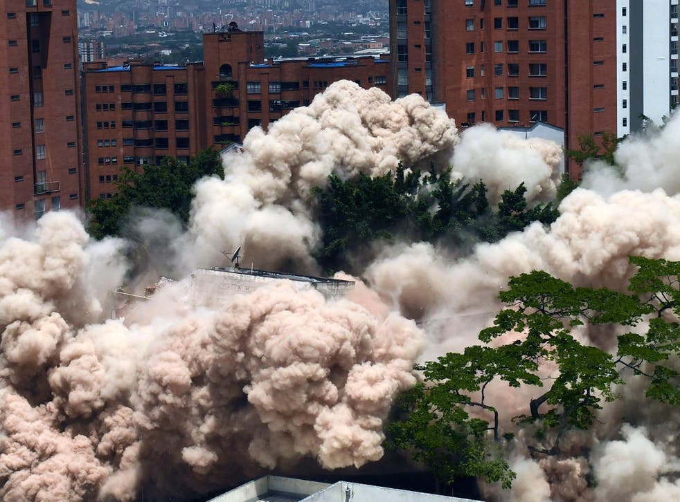 A dust cloud rises as the Monaco building in Medellin is demolished