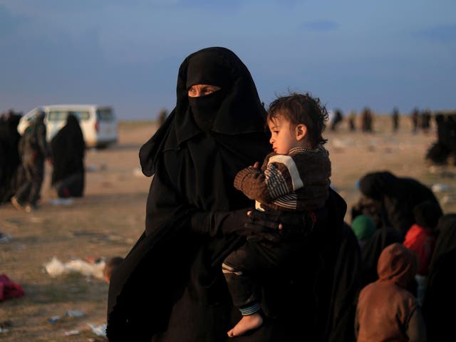 Women and children flee the Islamic State’s last holdout of Baghouz which is surrounded by US-backed forces