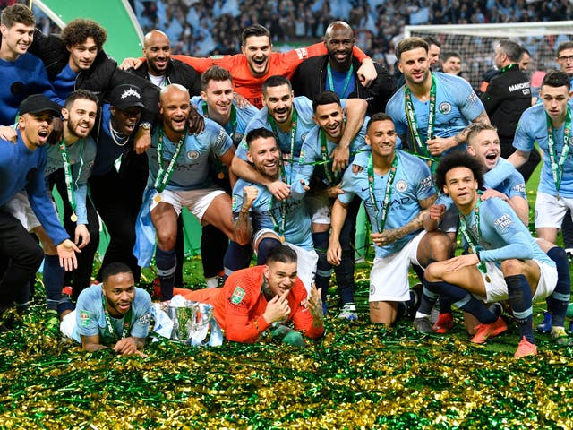 Manchester City's players celebrate with the trophy