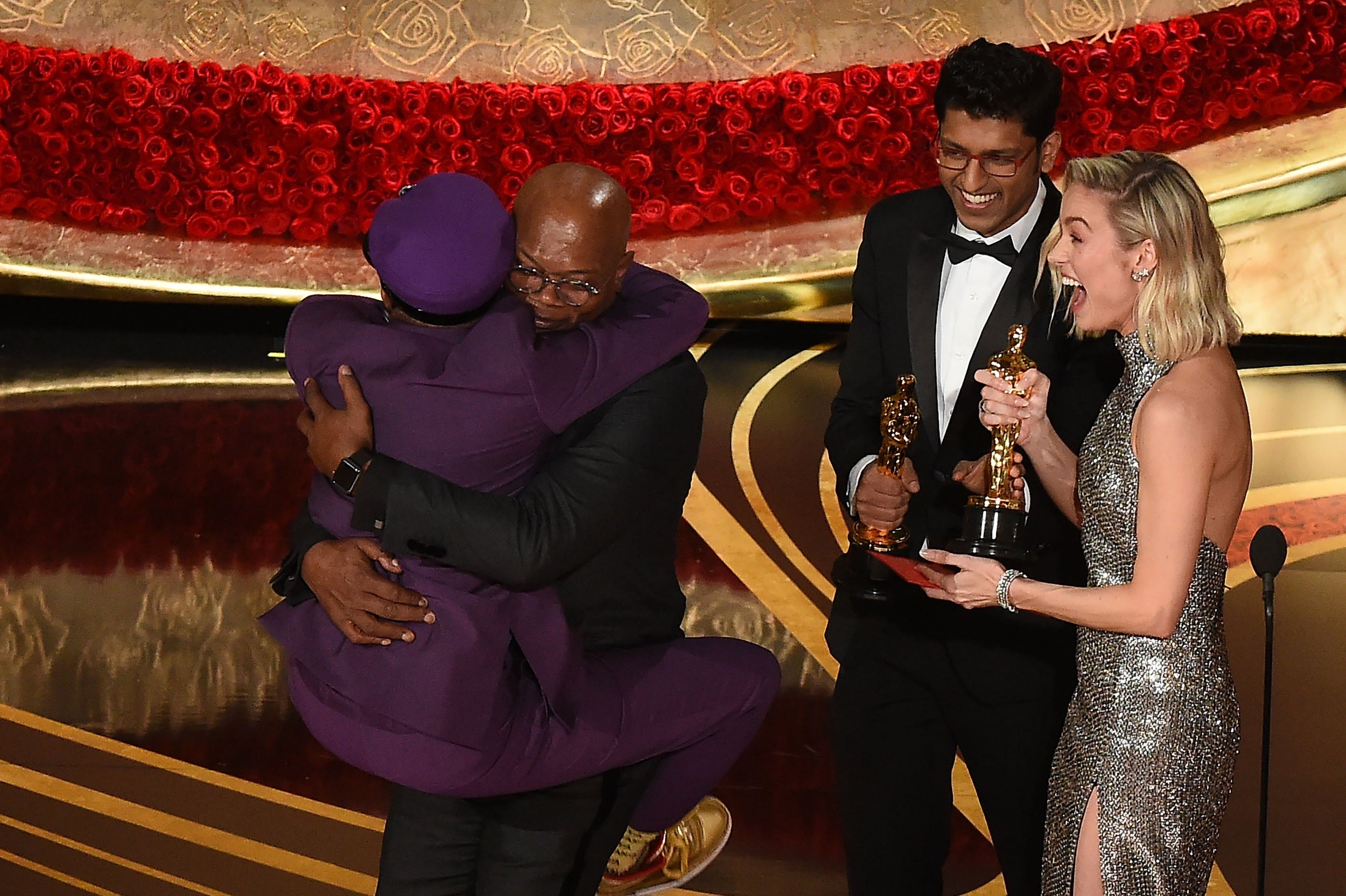 Spike Lee (left) jumps in the arms of Actor Samuel L Jackson as he accepts the award Best Original Screenplay for "BlacKkKlansman"