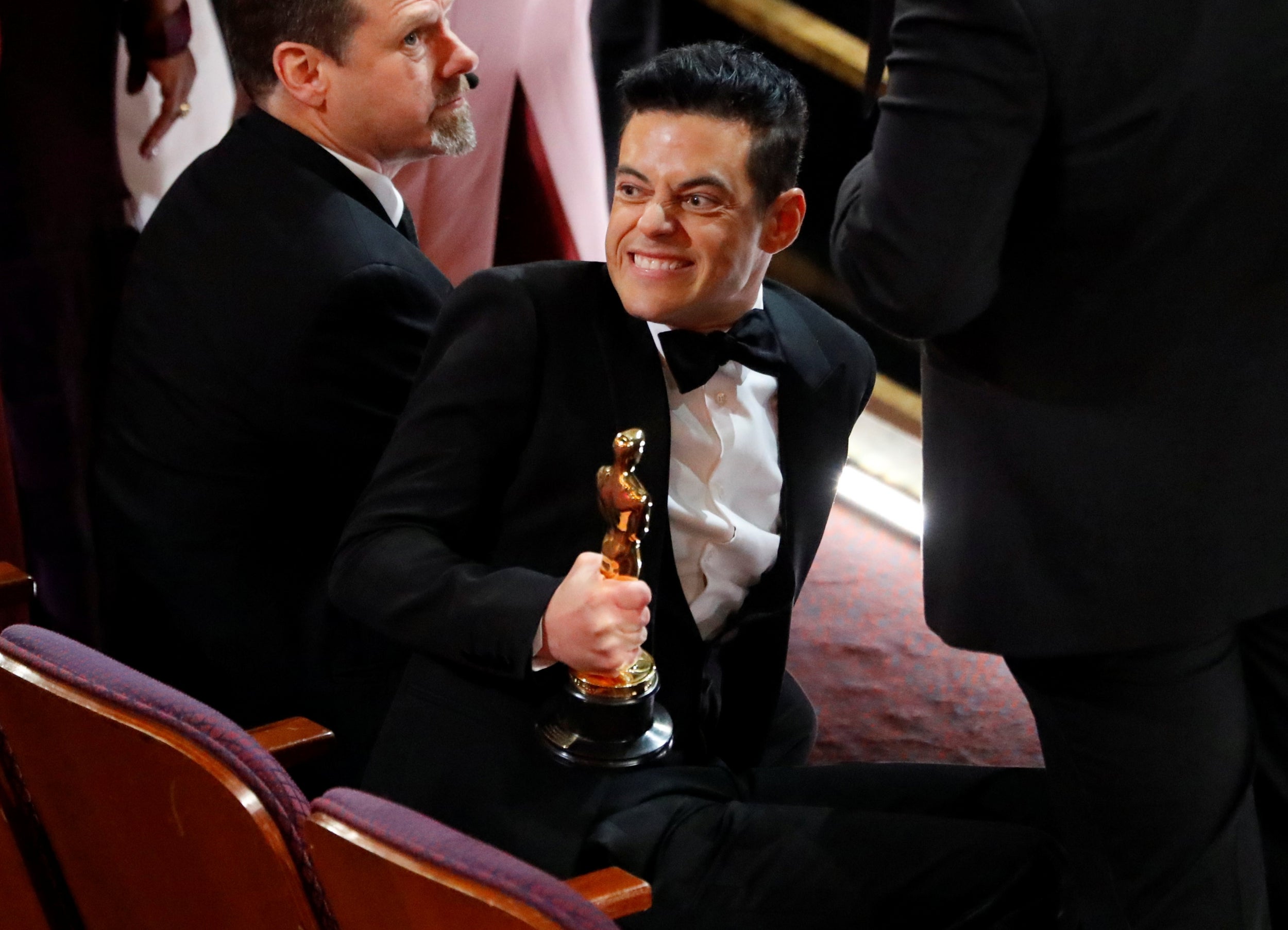 Rami Malek holds his Best Actor Oscar as he reacts after the show concluded
