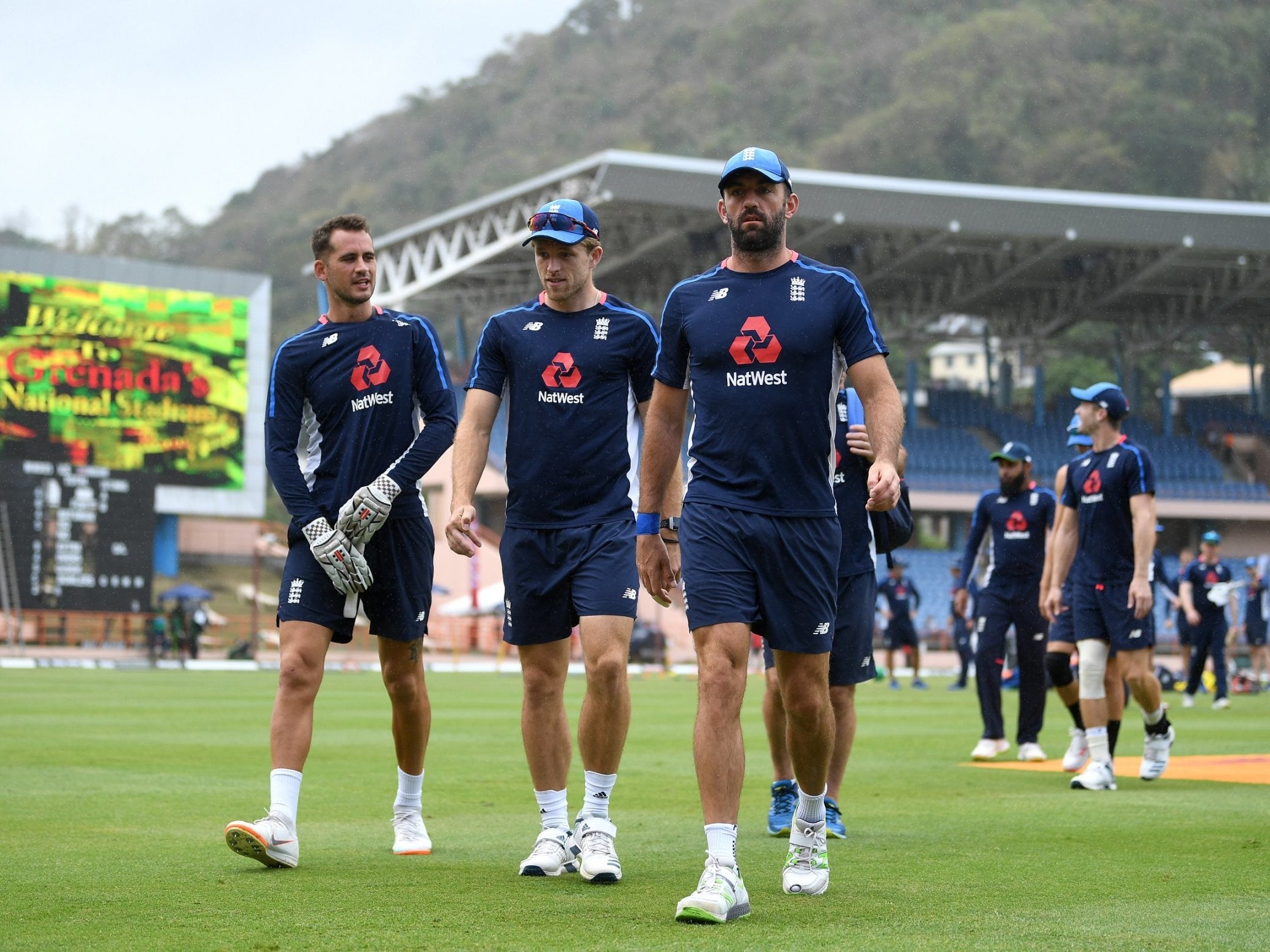 The England players leaving the field as rain begins to fall