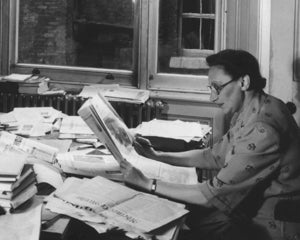 Eva Reichmann reading newspapers at the Wiener Library in July 1952