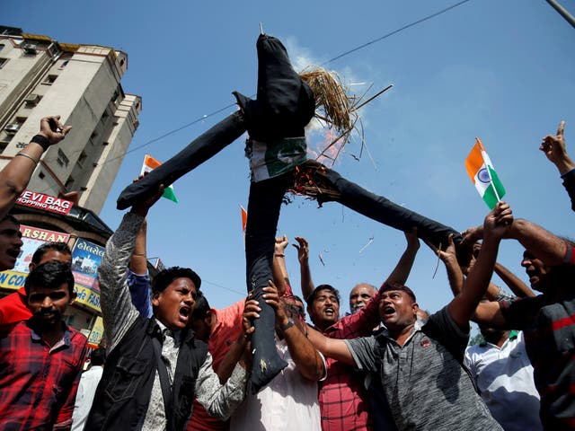 People burn an effigy depicting Pakistan as they celebrate after Indian authorities said their jets conducted airstrikes on militant camps in Pakistani territory
