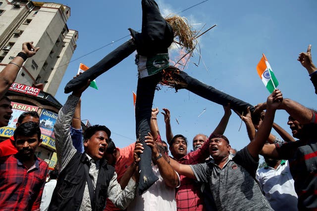 People burn an effigy depicting Pakistan as they celebrate after Indian authorities said their jets conducted airstrikes on militant camps in Pakistani territory