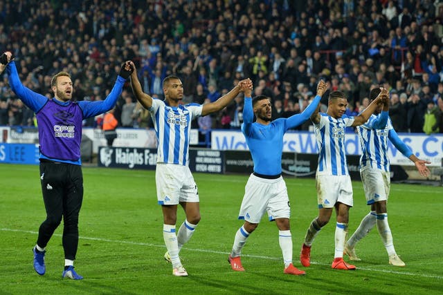 Huddersfield players celebrate with their supporters at full-time
