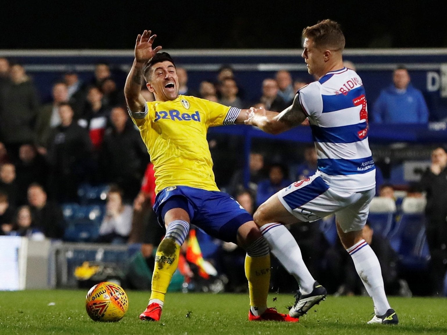 QPR's Jake Bidwell holds onto Leeds' Pablo Hernandez in attempt to secure possession