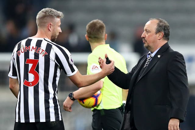 Paul Dummett of Newcastle United shakes hands with Rafael Benitez