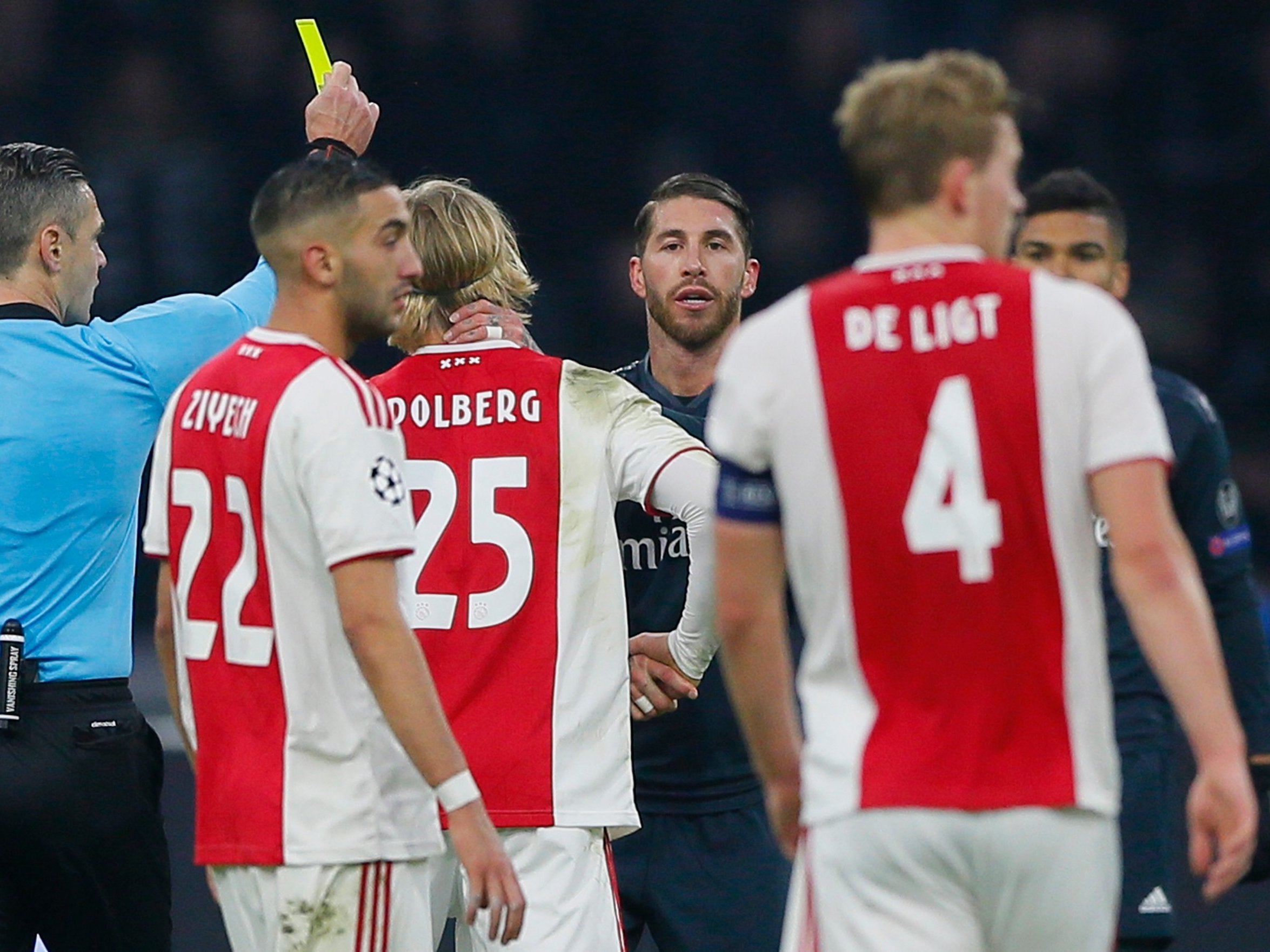 Real Madrid's Sergio Ramos receives a yellow card