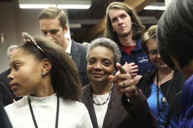Mayoral candidate Lori Lightfoot and her daughter Vivian Lightfoot appear with supporters at EvolveHer in Chicago Tuesday, Feb. 26, 2019.