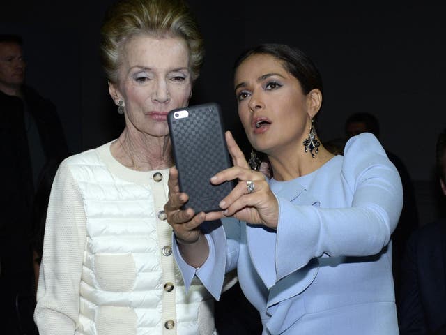 Radziwill poses for a selfie with actor Salma Hayek at a Paris fashion show in 2015