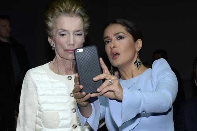 Radziwill poses for a selfie with actor Salma Hayek at a Paris fashion show in 2015