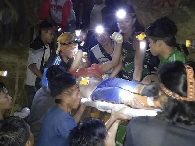 Rescuers evacuate a survivor from a collapsed gold mine in Bolaang Mongondow, North Sulawesi, Indonesia.