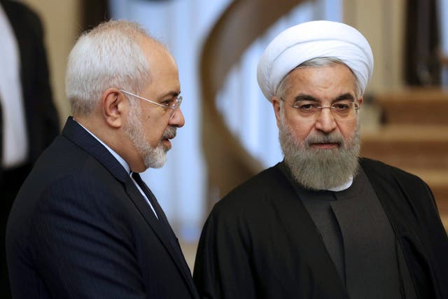 Iranian President Hassan Rouhani, right, listens to his Foreign Minister Mohammad Javad Zarif prior to a meeting in Tehran, Iran.