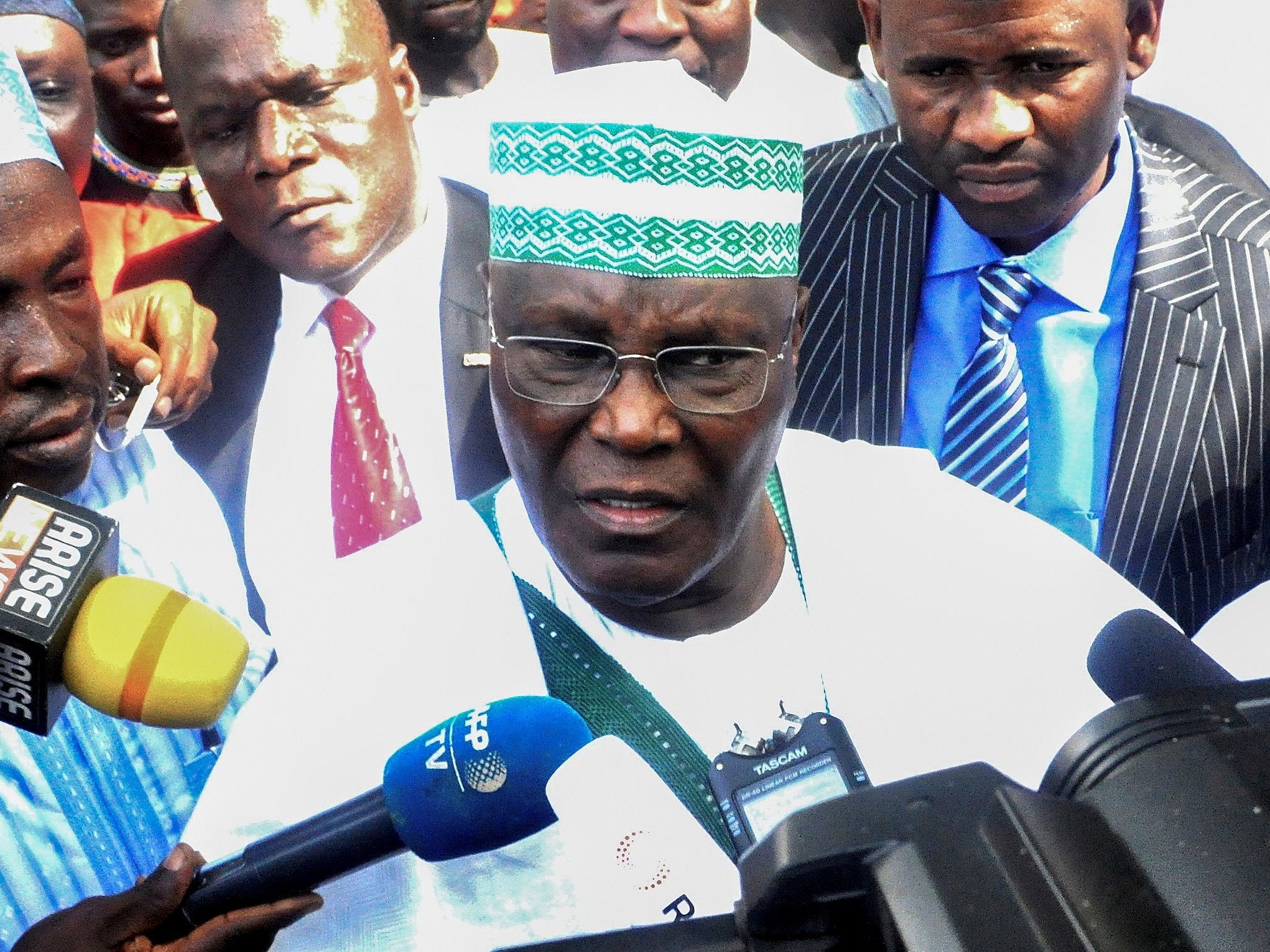 Opposition candidate Atiku Abubakar talks to the media after casting his ballot in the presidential election