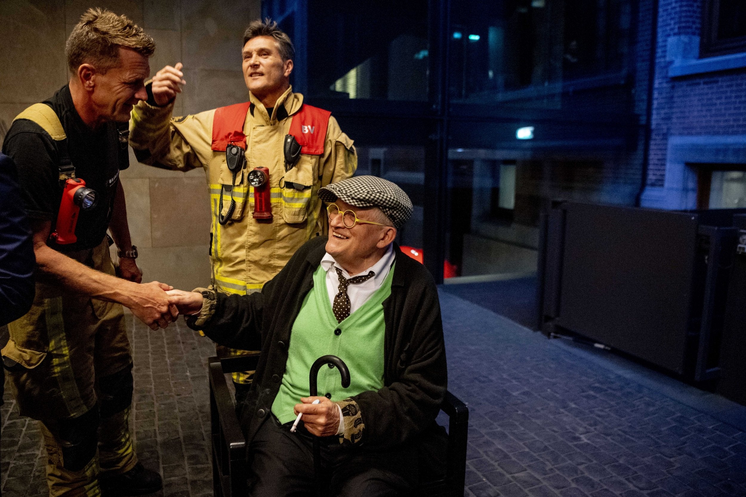 Hockney shakes hands with one of his rescuers